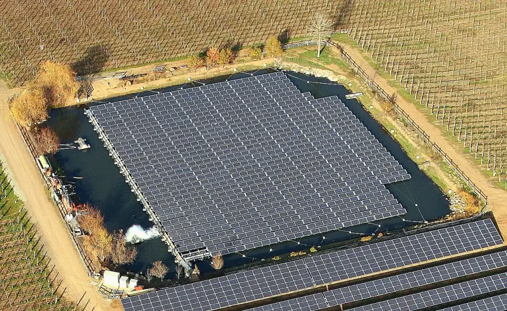 Floating solar panels mounted over a water surface.