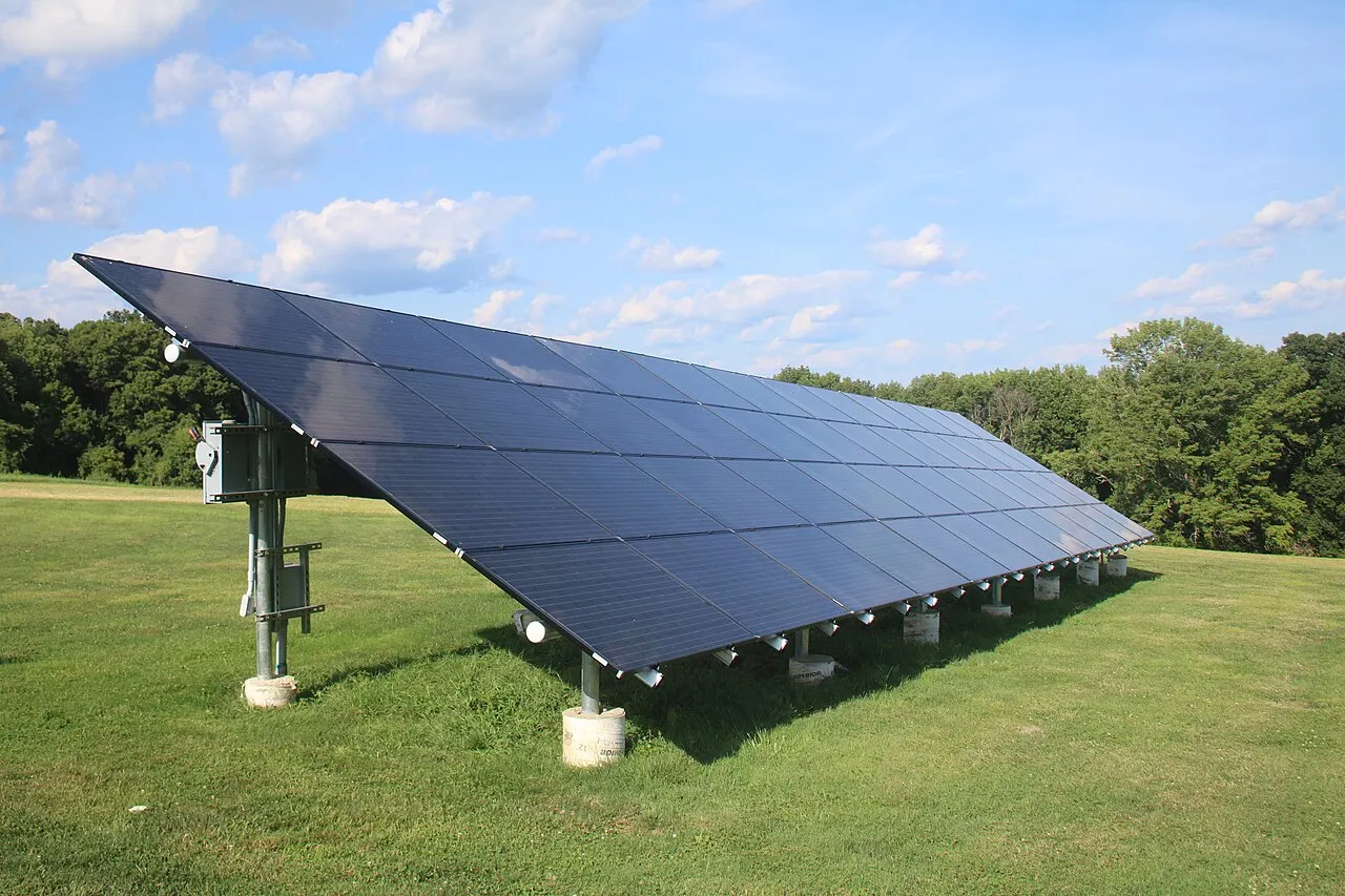 Ground-mounted solar panels installed in an open field.