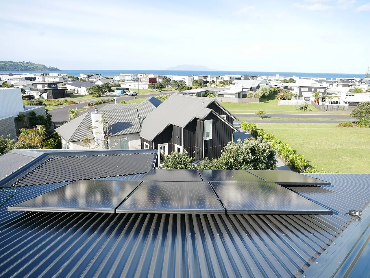 Solar panels mounted on a pitched rooftop.